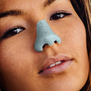 A tan girl wearing Nöz's zinc oxide and eco friendly spf on her nose 